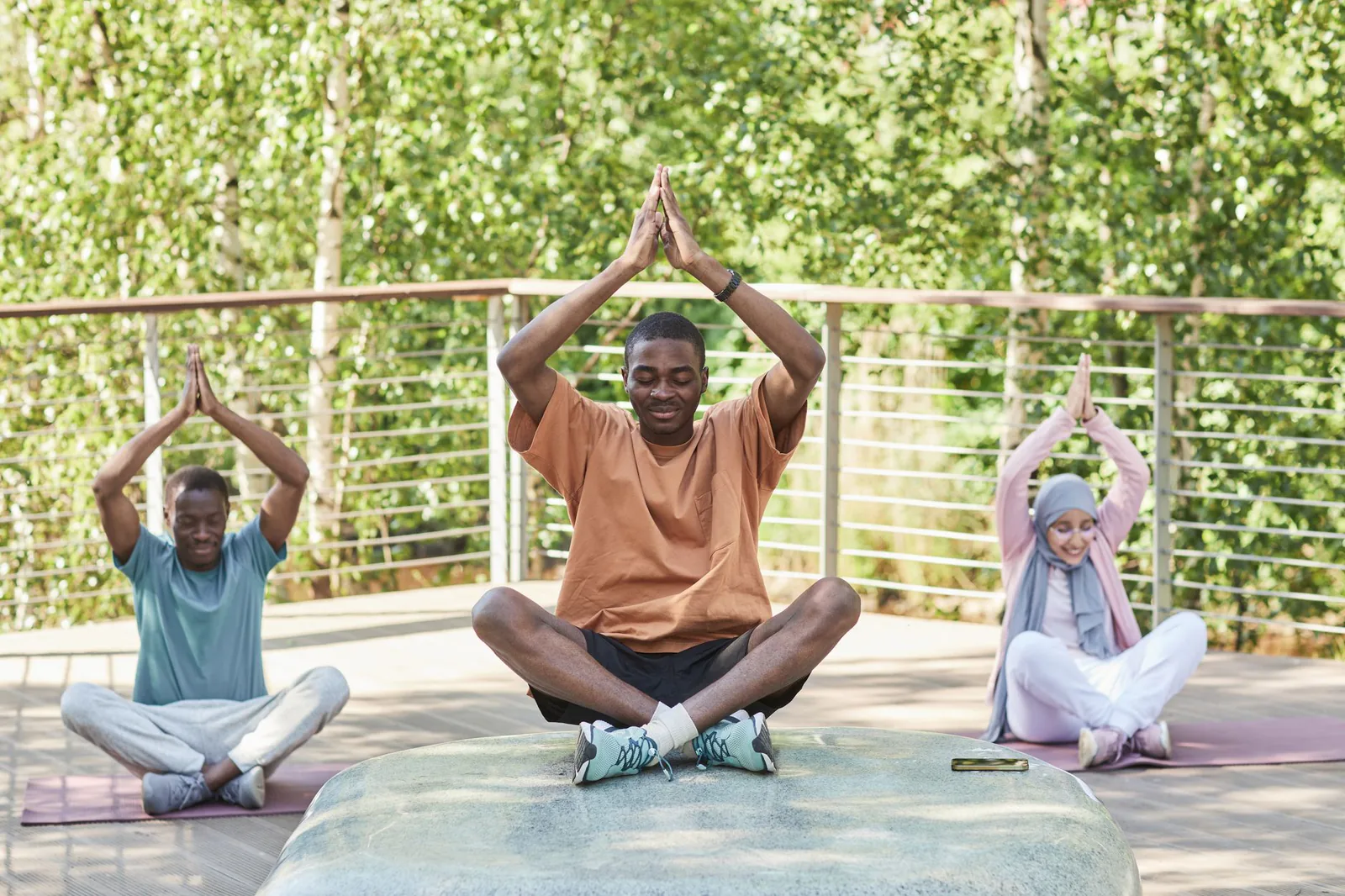 Yoga therapist guiding a student through a supported stretch
