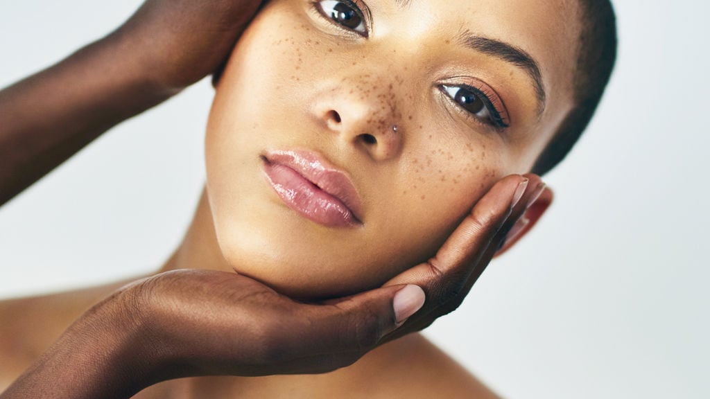 Close-up of a woman with closed eyes and a serene, softened expression in soft light