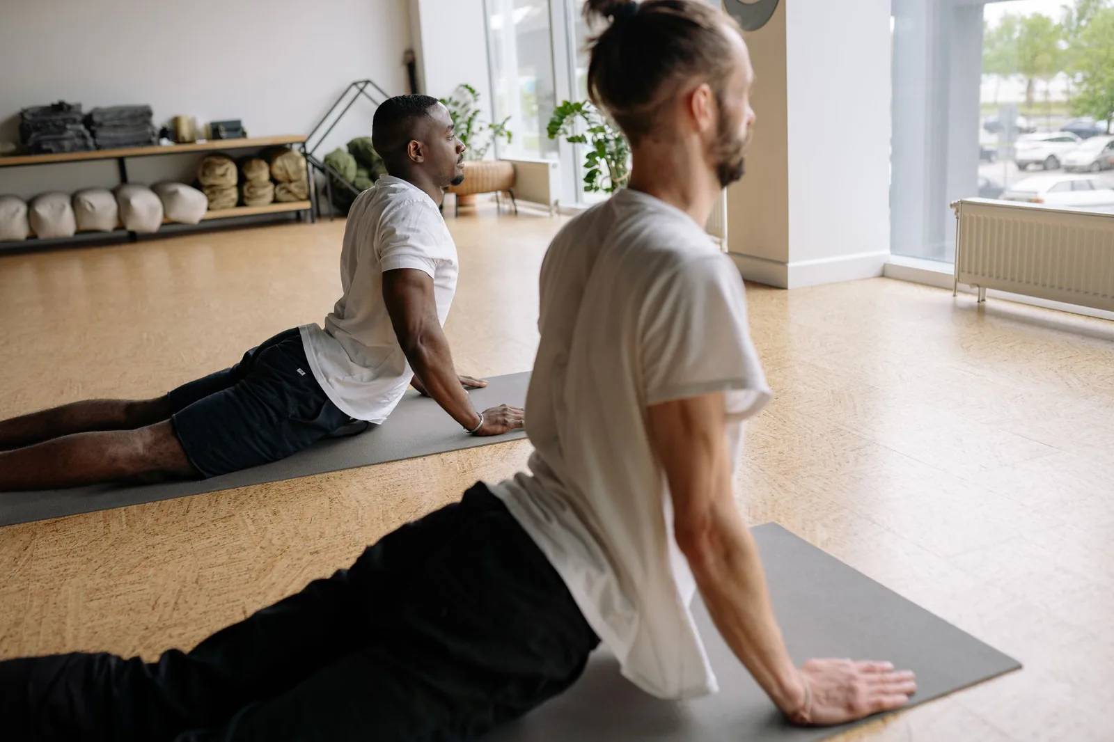 Men practicing yoga together in a studio